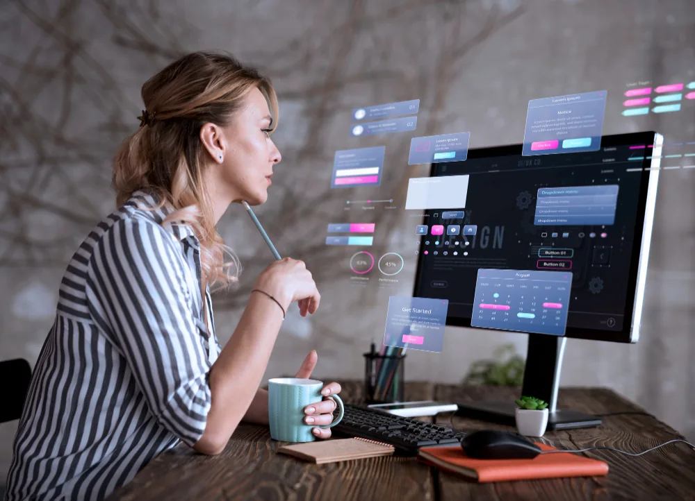 Designer reviewing website interface elements at a desktop computer